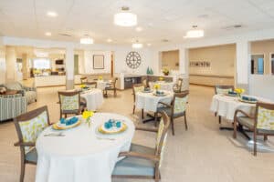 Dining tables set with linen tablecloths and soft seating at the Pacific Villas facility