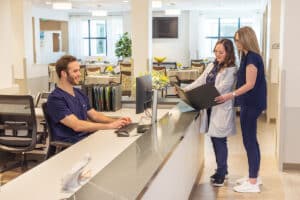 Three nurses at the nurses' station at the Pacific Villas facility