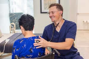 A caregiver with a resident at the Pacific Villas facility