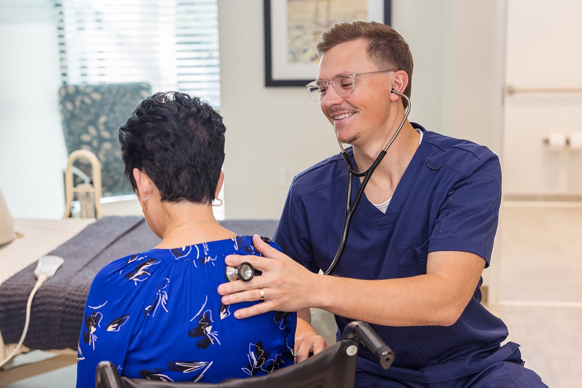 A caregiver with a resident at the Pacific Villas facility