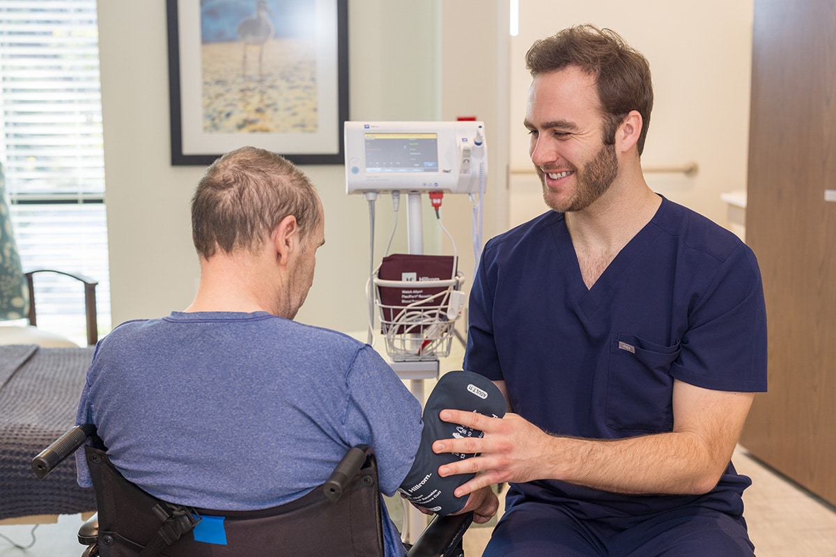 Caregiver with a resident at the Pacific Villas facility