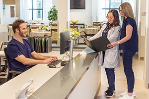 Three nurses at the nurses' station at the Pacific Villas facility