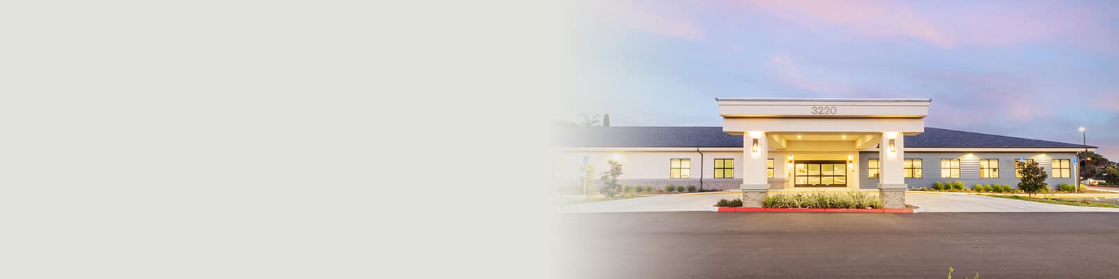 The front of the Pacific Villas facility with cotton candy clouds overhead
