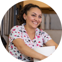 housekeeper holding cleaning supplies