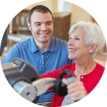 rehab nurse working with smiling elderly woman